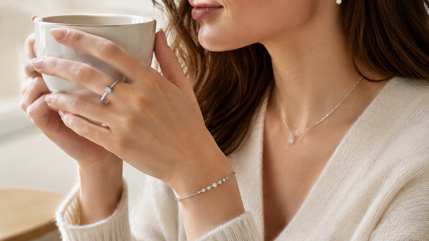 ILU520 jewelry worn in a close hand and neckline detail